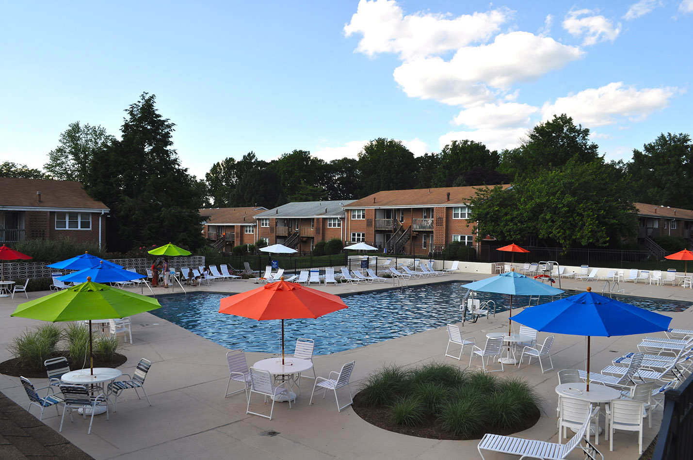 Outdoor shot of Radwyn Pool area with umbrellas, tables, and lounge chairs